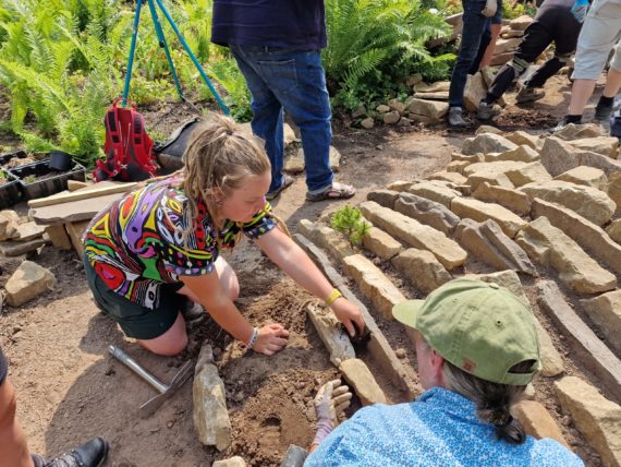 Participants helping build the crevice garden at Hartside Nursery during the AGS Young Person's Weekend 2023